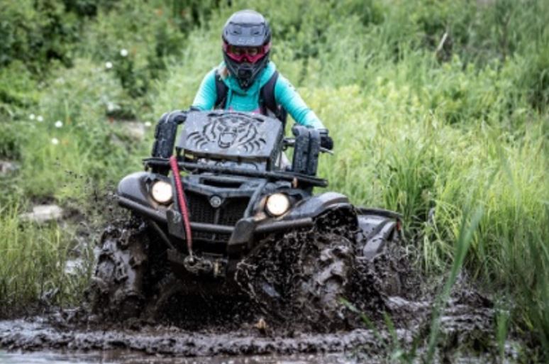 kyle riding her atv on the voyageur multi-use trail